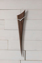 Black Walnut Stake Clock is made of one solid piece of rich Black Walnut. This clock is understated, yet demands attention simply because of the gorgeous wood. Pointed white metal hands create a nice contrast with the wood. At 29" high and 5.5" wide, it is an ideal piece for small spaces. Stake Clock is simple and elegant with just a bit of whimsy.