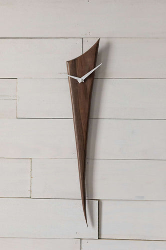 Black Walnut Stake Clock is made of one solid piece of rich Black Walnut. This clock is understated, yet demands attention simply because of the gorgeous wood. Pointed white metal hands create a nice contrast with the wood. At 29