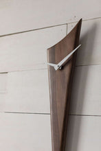 Black Walnut Stake Clock is made of one solid piece of rich Black Walnut. This clock is understated, yet demands attention simply because of the gorgeous wood. Pointed white metal hands create a nice contrast with the wood. At 29" high and 5.5" wide, it is an ideal piece for small spaces. Stake Clock is simple and elegant with just a bit of whimsy.